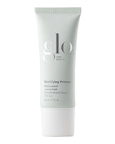 Tube des Glo Skin Beauty Mattifying Primers – glanzkontrollierender Primer mit mattem Finish, 30 mL (1 fl. oz.)